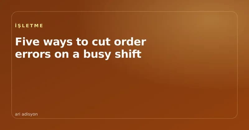A waiter taking an order on a tablet during a busy service